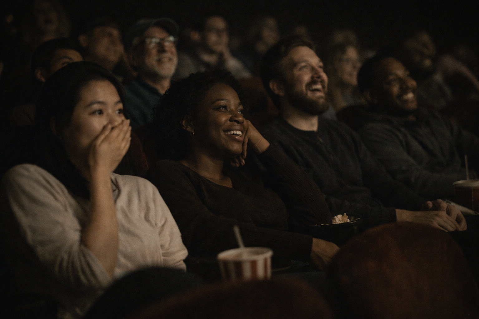 Audience reacting in a theater (placeholder)